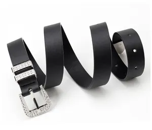 Detail view of black rhinestone-studded buckle and lychee texture on punk style belt
