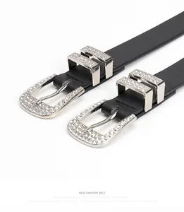 Macro detail of high-quality black leather belt with sparkling rhinestone buckle and loops
