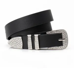 Close-up of black leather belt featuring ornate rhinestone buckle and western stud detailing