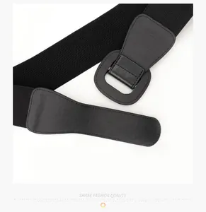 Detailed view of women's wide black elastic belt with matching leather buckle on white