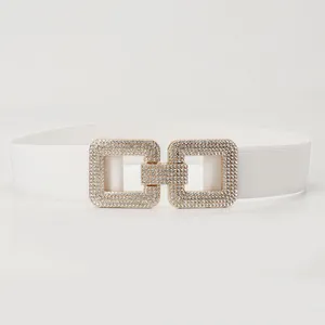 Elegant white elastic waist belt featuring a sparkling rhinestone interlocking buckle