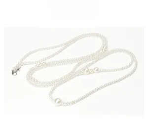 Detail of elegant multi-layer pearl necklace featuring large focal beads and lobster clasp