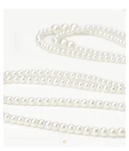 Detailed close-up showing the high-luster white pearls and elegant multi-layer strand texture