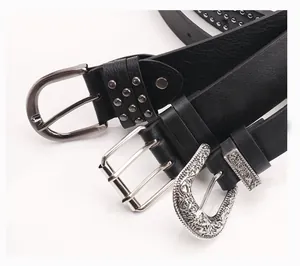 Detailed close-up of three black leather belts featuring punk rivet and western buckle designs