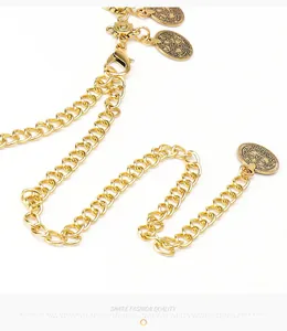 Close-up of gold metal waist chain featuring vintage coin charms and lobster clasp