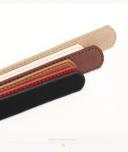 Detailed view of suede and grain leather belt straps in various stylish colors with stitching
