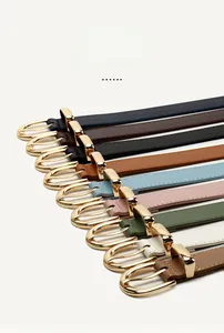 Close-up of minimalist leather belts with golden alloy buckles in various colors