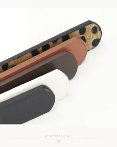 Detail view of leopard print and assorted leather belts with smooth edge oil finishing