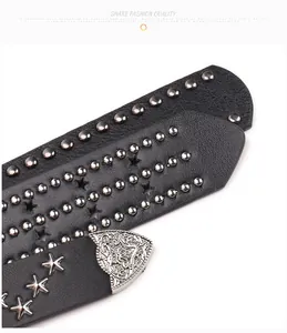 Detailed macro of punk leather belt featuring silver star studs and vintage metal tip