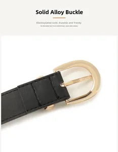 Close-up of a gold D-ring alloy buckle and black lychee texture leather belt strap
