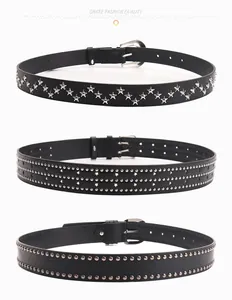 Detailed view of black punk belts with silver star and dot studs on leather texture