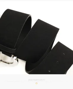 Close-up of black suede wide belt featuring a polished silver buckle and matte texture