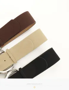 Detail of wide PU suede belts with metallic buckles in black, beige, and dark brown
