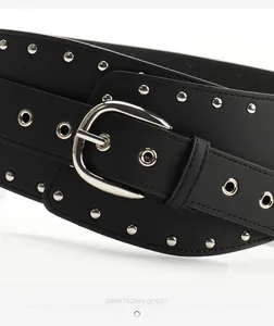 Close-up of black punk waist belt with silver studs and polished metal buckle