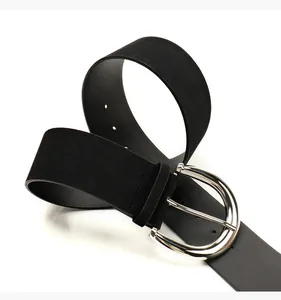 Detail of black PU leather waist belt featuring a large silver D-ring buckle and sleek texture
