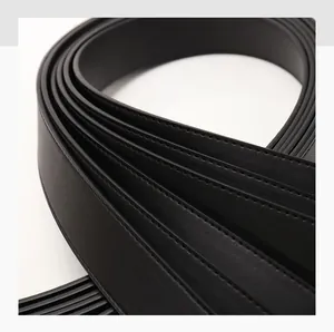Close-up of black leather belt showing refined texture and precision edge stitching
