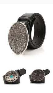 Close-up of vintage Western belt buckles with ornate floral engraving and turquoise stone
