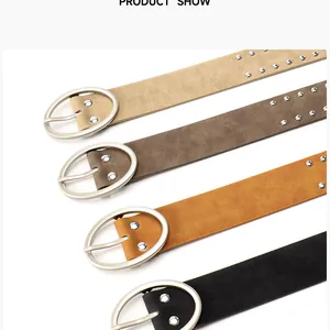 Detail of four retro leather belts with metallic studs and oval buckles in various colors
