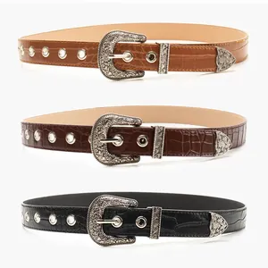 Three western vintage belts with carved alloy buckles and embossed leather textures