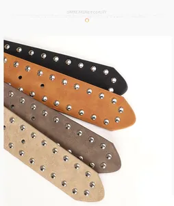 Detail of four studded leather belts in black, camel, brown and beige colors with rivets