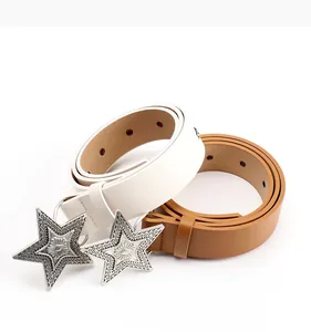 Close-up of white and brown leather belts featuring silver star buckles and embossed details