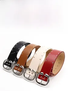 Close-up of four colors of PU leather belts with double rivets and silver C-shaped buckles