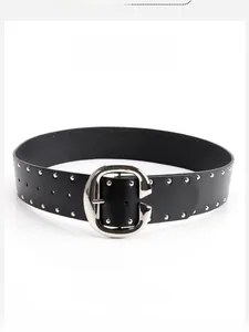 Detail of black leather belt with double silver rivets and large C-shaped metal buckle