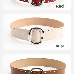 Detail view of retro double-row rivet belts in red, beige and brown with large C-buckle