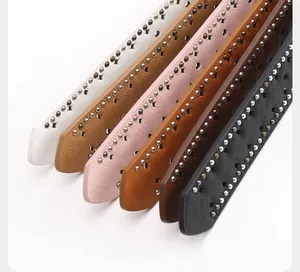 Detail of Y2K waist belts featuring double-row metal rivets and star-shaped cutouts