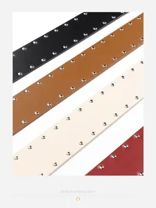 Detail of vintage leather belts with double-row silver rivets and metallic C-buckle