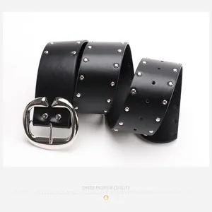 Macro view of vintage black leather belt with silver double-row studs and oval buckle