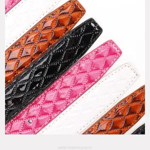 Macro view of glossy quilted leather belts with Julun letter buckle and rhombus patterns