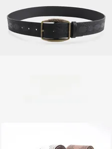 Detailed view of black leather belt with embossed patterns and bronze buckle