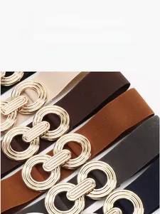 Close-up of elastic waist belts with double ring alloy buckle in multiple colors
