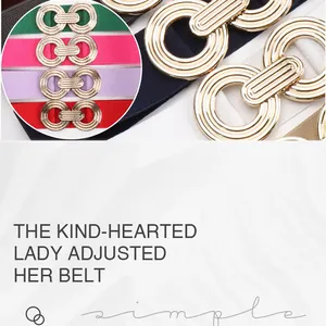 Close-up of stylish elastic belts with geometric gold-tone interlocking circle buckles