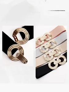 Elastic waist belts in multi-colors with geometric gold alloy buckles on marble background