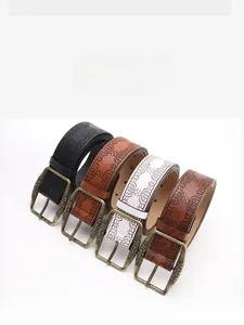 Close-up of vintage embossed leather belts in four colors with antique bronze buckles