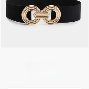Close-up of golden interlocking double-ring buckle on a black elastic belt for women