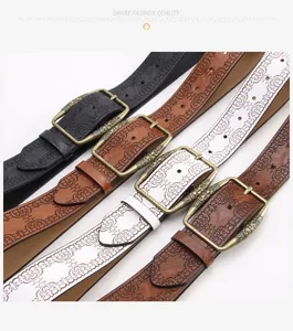 Detail of embossed floral patterns on vintage Y2K leather belts in black, brown, and white