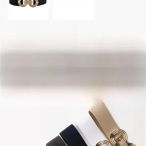 Close-up of elastic waist belts in black, white and khaki with gold geometric buckles