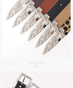 Detailed close-up of vintage silver buckles on leather belts with leopard print and solid colors