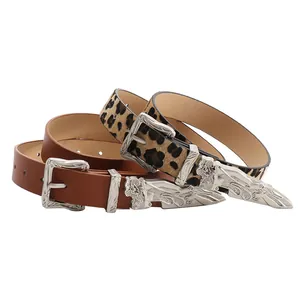 Western style belts featuring leopard print and brown leather with floral carved metal buckles