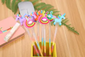 Close-up of colorful cartoon unicorn and flamingo pens in a yellow holder on desk