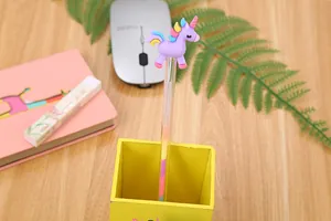 Close-up of a purple unicorn gel pen with rainbow hair in a yellow desk organizer