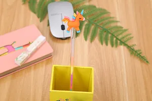 Creative cartoon unicorn gel pen detail with orange unicorn topper in a yellow desk organizer