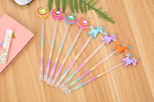 Flat lay of 8 unicorn and flamingo multi-color gel pens on a light wooden desk