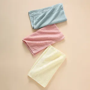 Detailed close-up of soft waffle weave texture on absorbent cotton face towels