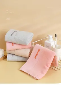 Macro detail of thick absorbent cotton face towels with Goodness embroidery in a basket