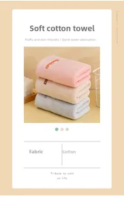 Macro detail of soft cotton towels with embroidered text in pink, beige and grey