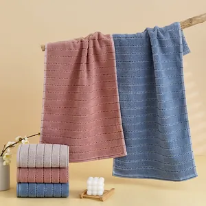 Detailed waffle texture of thick cotton towels in pastel colors for bathroom decor